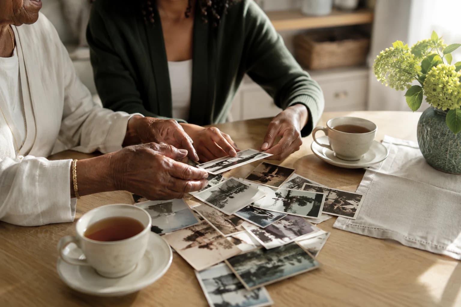 Two generations looking through family photographs together